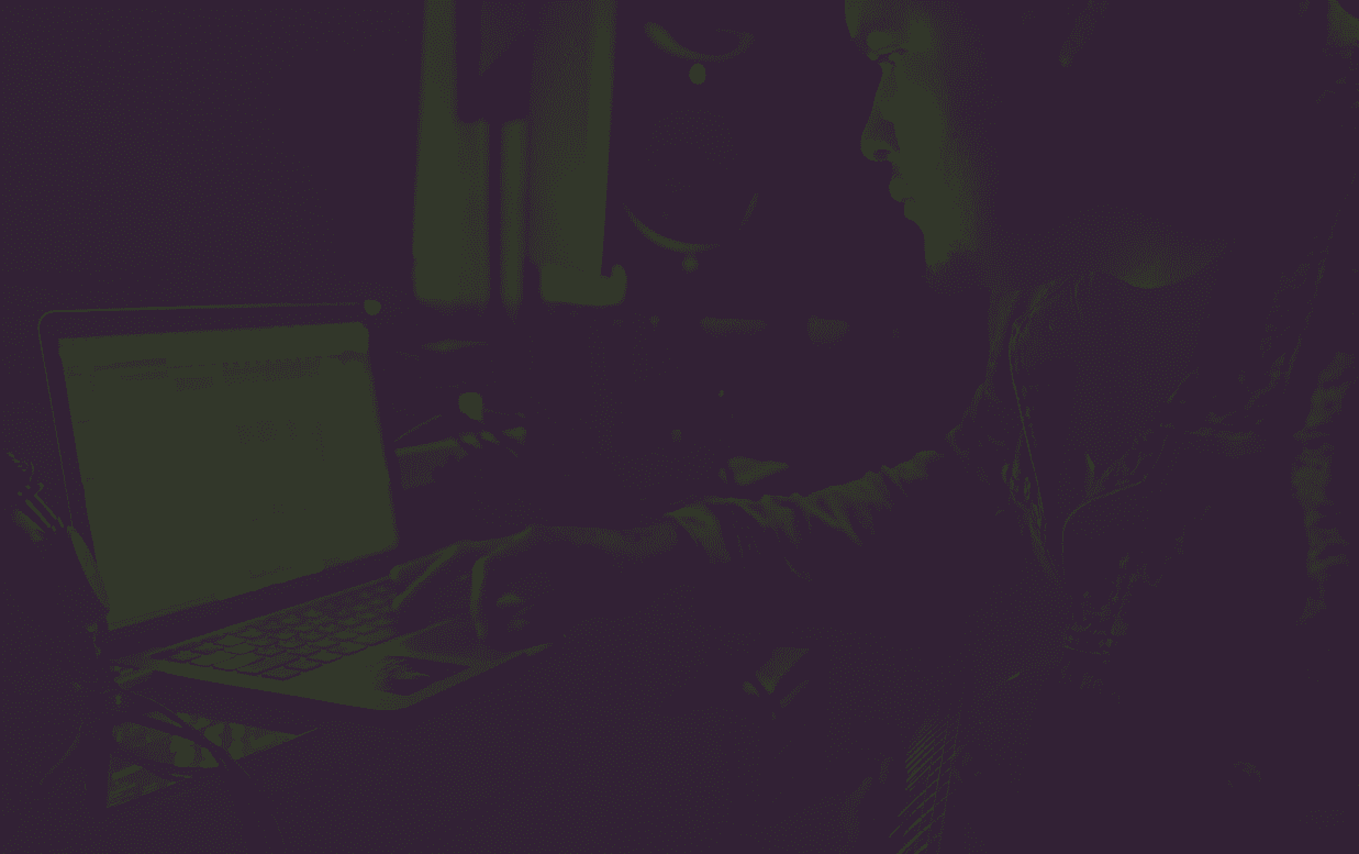 Independent music producer creating tracks in professional studio with community-driven platform on screen